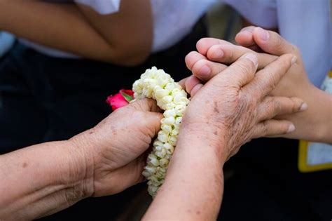 Premium Photo Close Up Of Woman Hand Holding Red Rose Flower