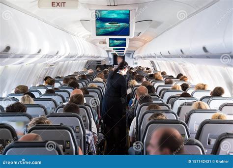 Inside View On Passenger And Cabin Crew People On An Airline Airplane During Flight Vacation