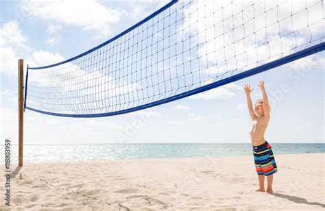 Cute Kid Boy On Background Volleyball Net And Sunny Ocean Beach Child