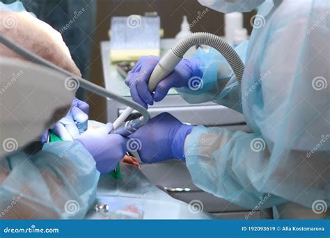 A Dentist Performs An Operation To Treat Deep Caries Under General