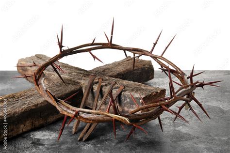 Crown Of Thorns With Wooden Cross And Nails On Table Against White