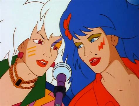 Two Women With Blue Hair Are Talking To Each Other And One Is Holding A Microphone