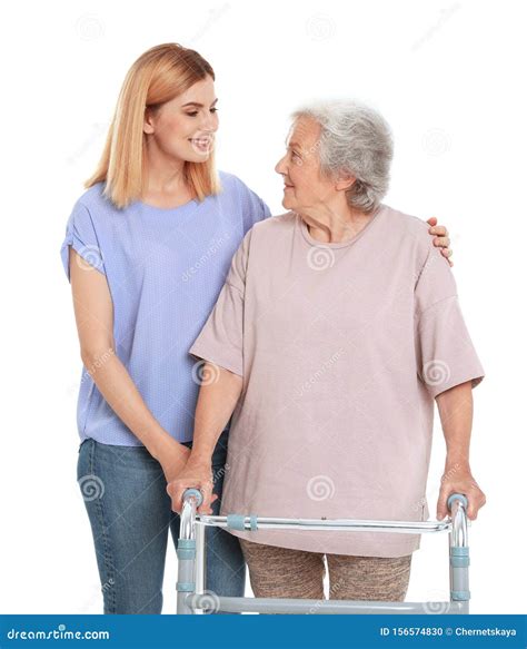 Caretaker Helping Elderly Woman With Walking Frame On White Stock Photo