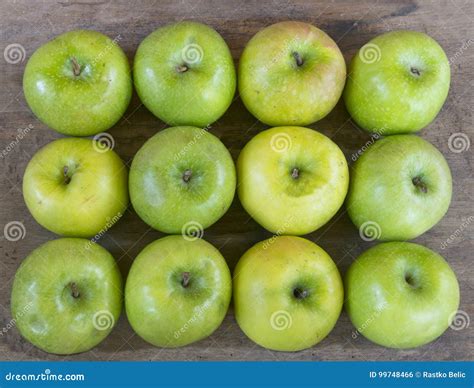 Large Group Of Healthy Green Apples On Wooden Table Stock Photo