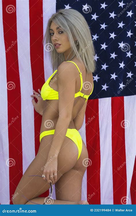 A Lovely Bikini Model Poses With The American Flag For The Holiday