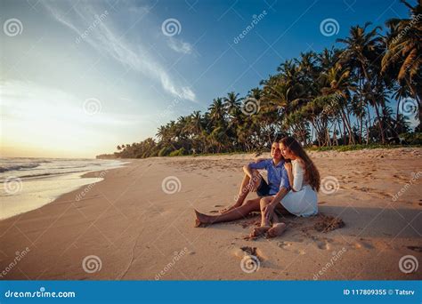 Happy Romantic Couple Sitting On Tropical Beach On Palm Trees