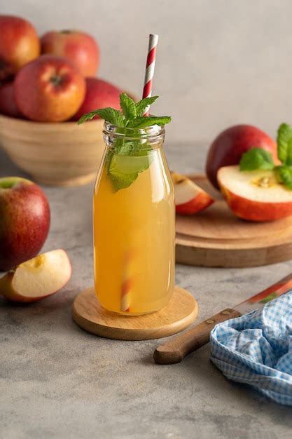 Premium Photo Apple Juice In Glass Bottle With Fresh Mint And Red