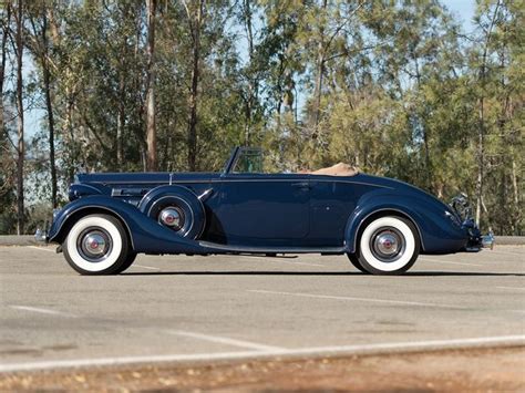 An Antique Blue Car Parked In A Parking Lot