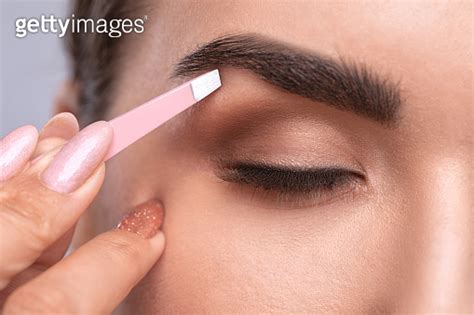 Makeup Artist Combs And Plucks Eyebrows In A Beauty Salon Professional