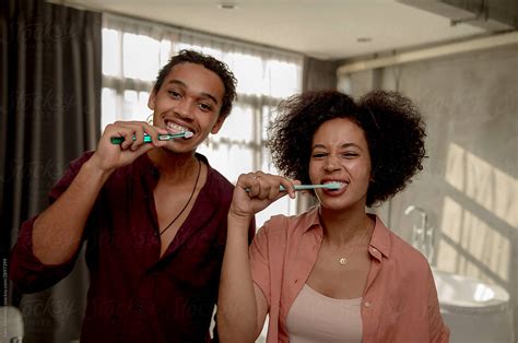 Couple Brushing Teeth Together By Stocksy Contributor Jovo Jovanovic