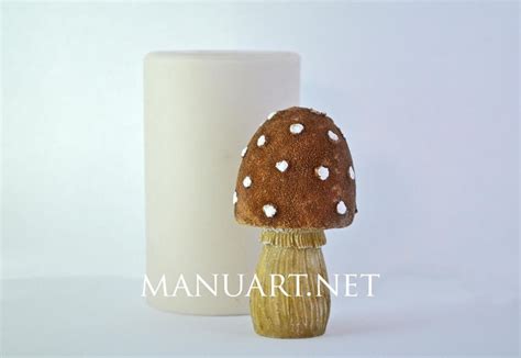 A Small Mushroom Sitting Next To A White Cup