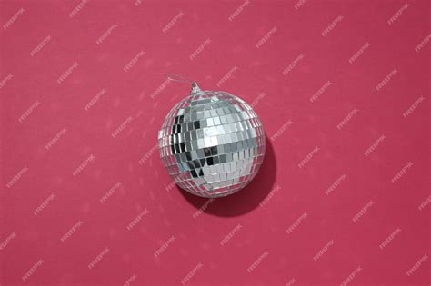 Premium Photo | Beautiful disco ball on a red background