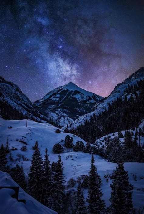 Starry Night Sky Above Snowy Mountains