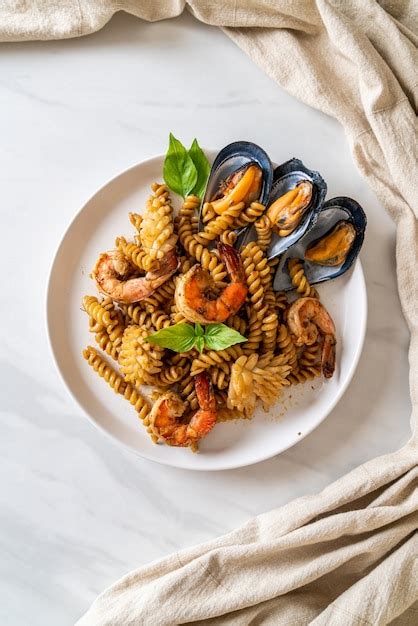 Premium Photo Stir Fried Spiral Pasta With Seafood And Basil Sauce