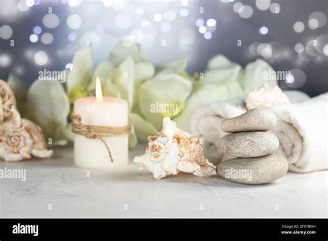 Massage Stones Seashell Burning Candles Rolled Towels Sea Salt Flowers Abstract Lights