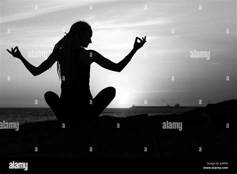 Black And White Silhouette Of Yoga Woman Meditation On The Sea Beach