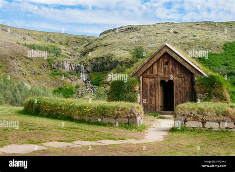 Icelandic Viking Longhouse With Waterfall In Background