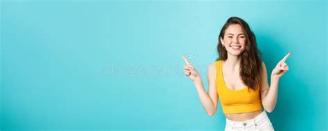 Young Pretty Woman Smiling And Laughing Happy Showing Two Ways Pointing Fingers Sideways At