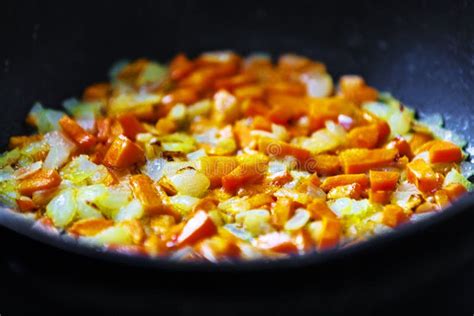 Chopped Onions And Carrots Fry In Vegetable Oil In A Frying Pan Stock