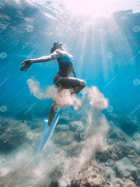 Freediver Woman Glides Underwater With Sand In Hand Free Diver With