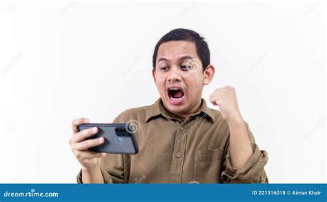 Wow And Happy Face Expression Of Young Asian Malay Man With Brown Shirt