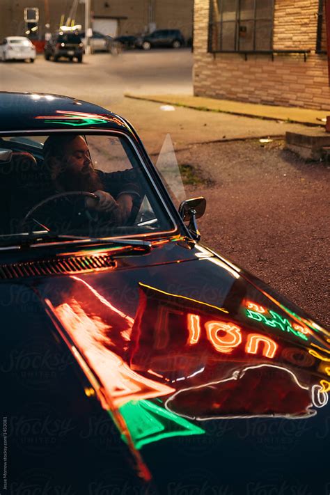 Male Driving Classic Vintage Retro Car At Night Under Neon Lights In