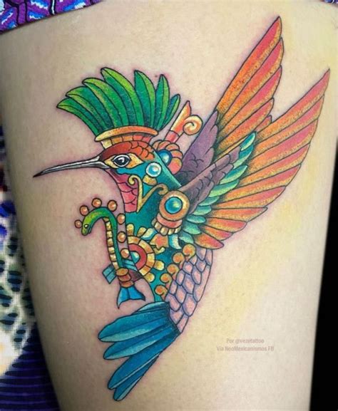 A Colorful Bird Tattoo On The Side Of A Woman S Thigh With An