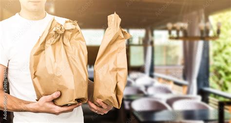 Two Boxes With Fast Food Being Carried By Delivery Man In Uniform For