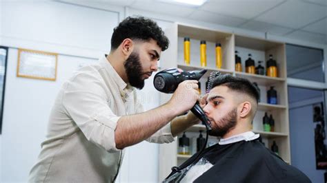 The Process Of Haircuts In A Barbershop Close Up Of Drying Hair With A