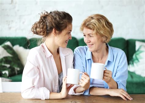 Premium Photo Two Beautiful Women Mother And Daughter Drink Coffee