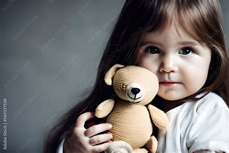 Lonely And Sad Beautiful Baby Girl Sitting Hugging A Soft Teddy Bear