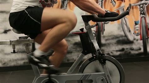 A Man Doing Exercises On Stationary Bike In The Gym YouTube