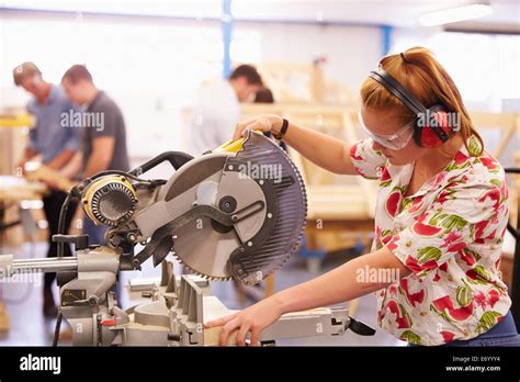 Female Student In Carpentry Class Using Circular Saw Stock Photo Alamy