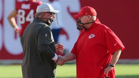 Two Football Players Shake Hands On The Field