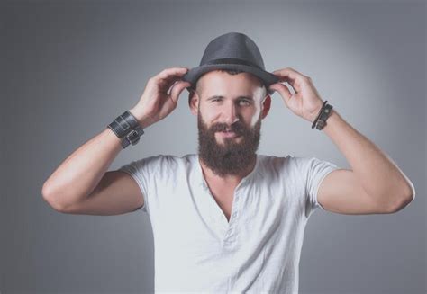 Premium Photo A Man With A Beard Wearing A Hat