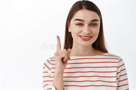 Close Up Portrait Of Young Attractive Woman Pointing Finger Up Showing Top Advertisement And