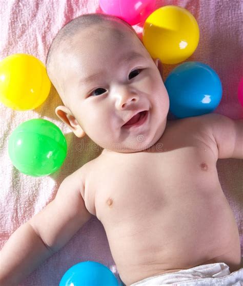 A Happy 3 Months Old Baby In A Bath Of Balls Stock Photo Image Of