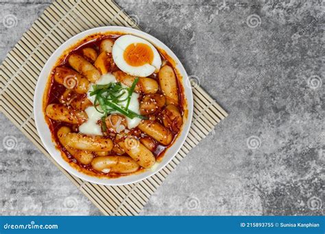 Top View Tteokbokki Spicy Rice Cakes with Boiled Eggs and Cheese on the Grey Concrete Table ...