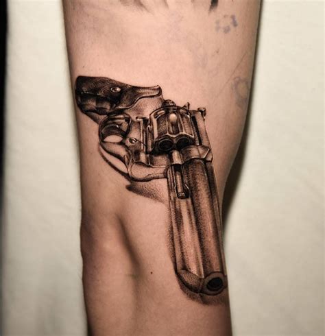 Revolver Tattoo Located On The Elbow Black And Grey