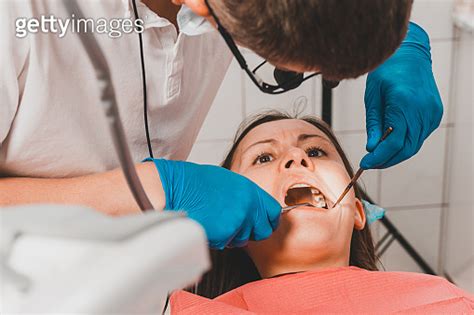 The Dentist Examines The Oral Cavity Before Treating The Problem Areas