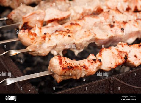 Shish Kebab In Process Of Cooking On Open Fire Outdoors Juicy Slices