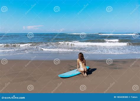 Back View Of Of Beautiful Sporty Surfing Woman In Bikini Sit Near