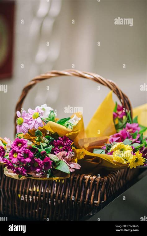 Thatch Basket Full Of Colorful Flowers In Cafe Restaurant Stock Photo