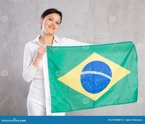 Pretty Smiling Female Football Fan Holding Brazilian Flag Stock Photo