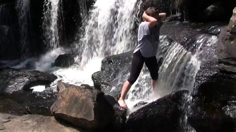 Young Woman Playing In Waterfall On Sunny Day Youtube