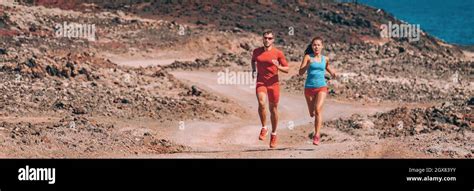 Runners Training Trail Running Fast In Desert Landscape Panoramic