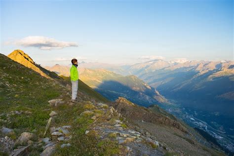 Premium Photo | Woman watching sunrise over the alps