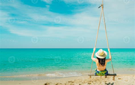 Asian Woman Wear Swimwear And Hat Swing The Swings At Sand Beach And