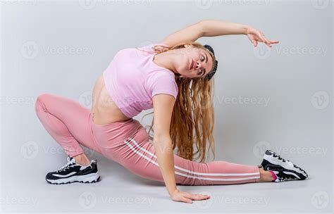 Acrobat Woman Wearing Pink Sportswear Stretching In The Studio Isolated