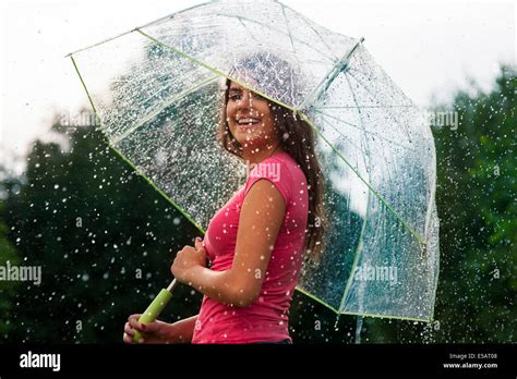 Young woman standing in summer rain with umbrella Debica, Poland Stock ...